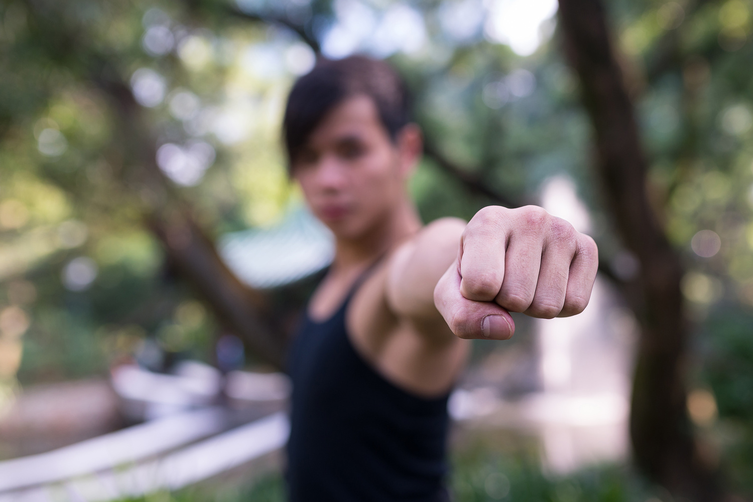 Young Man Portrait Practicing Kung Fu in a Park in Hong Kong
